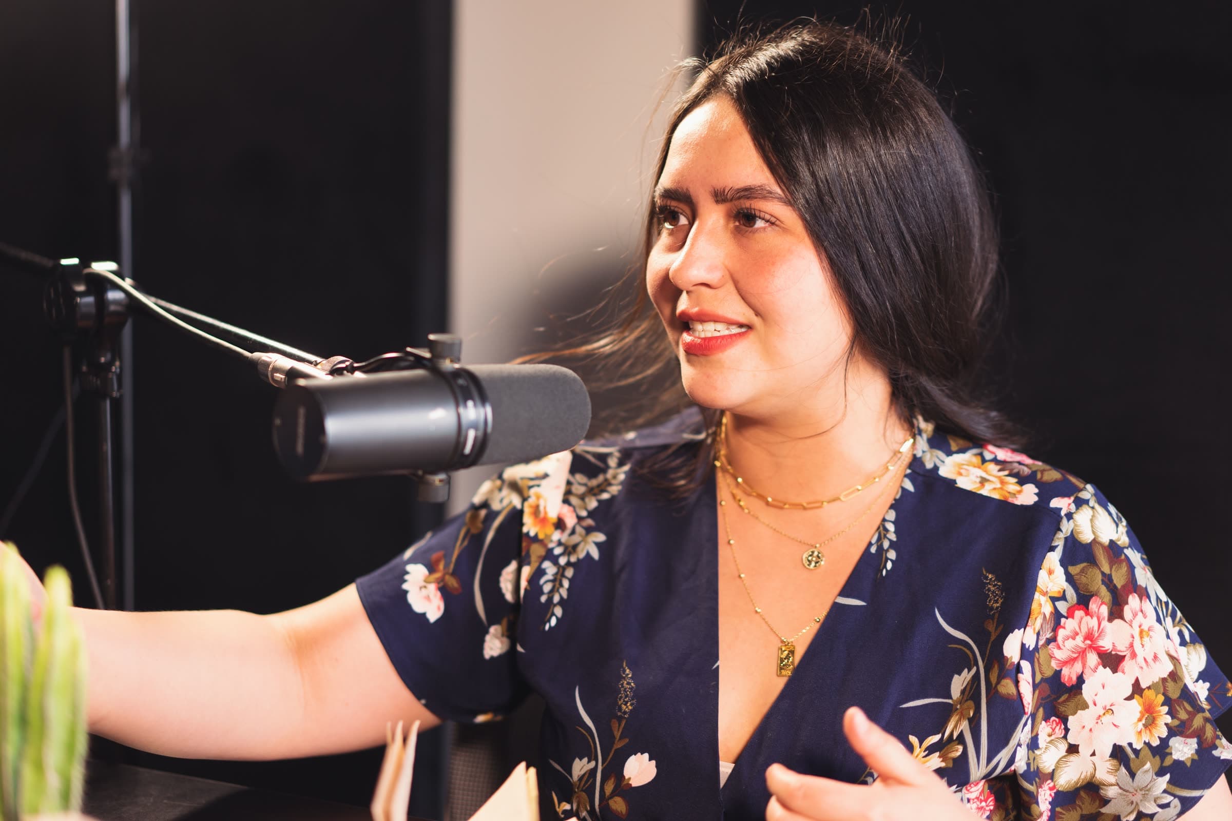 A guest laughing mid-answer in front of a broadcast microphone